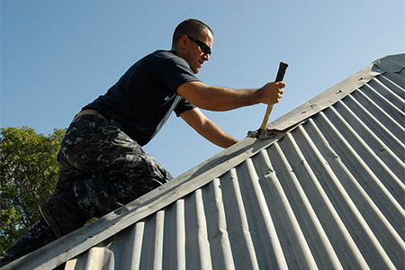 man repairing roof