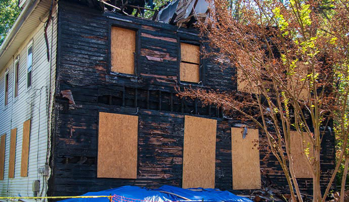Boarded up house after fire damage restoration