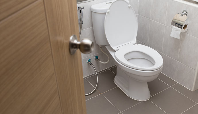 Clean toilet with a tiled bathroom floor