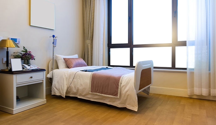 Clean nursing room with a medical bed