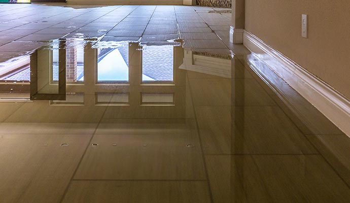 Standing water on tile floor from flood damage