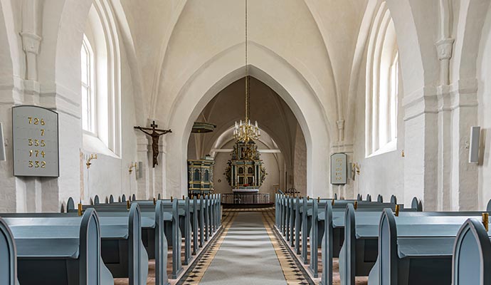 Historic church interior Historic church interior featuring blue wooden pews and ornate altar