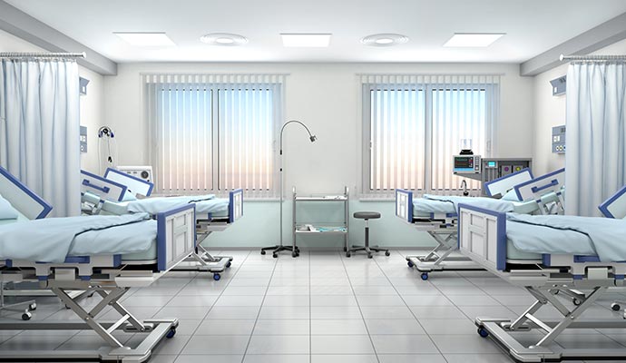 Modern hospital room featuring adjustable beds and medical equipment