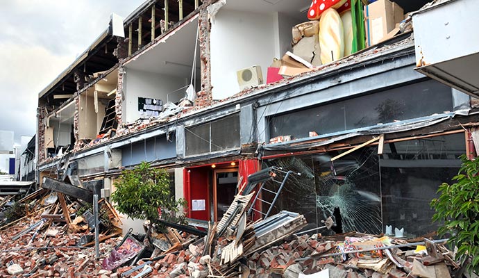 Storm-damaged commercial building Storm-damaged commercial building with collapsed facade and debris