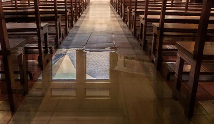 Flooded church with water on wooden floor Flooded church interior showing water on the wooden floor