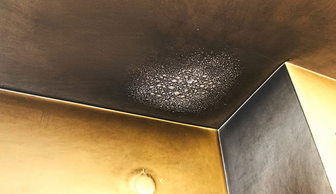 Soot and condensation on a fire-damaged ceiling