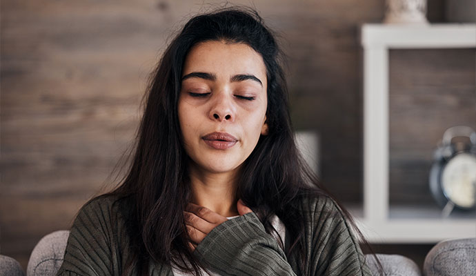 Woman suffering from respiratory irritation due to smoke odor