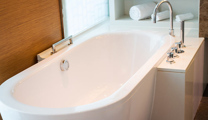 Modern white bathtub with chrome fixtures
