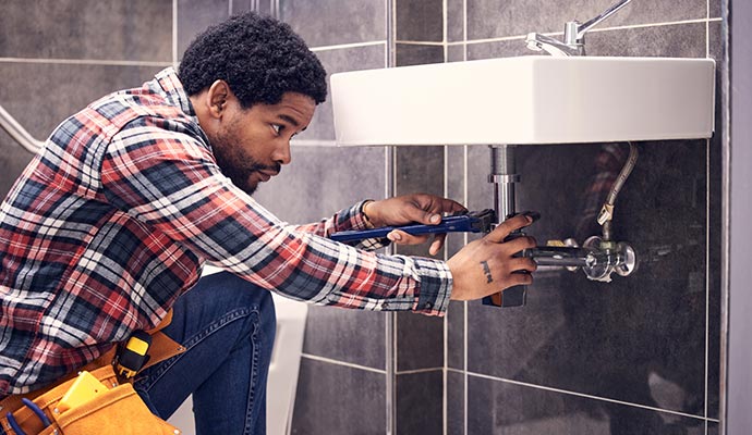 A plumber is fixing basin