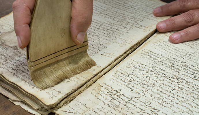 Professional documentation restoration services Professional worker restoring damaged documents