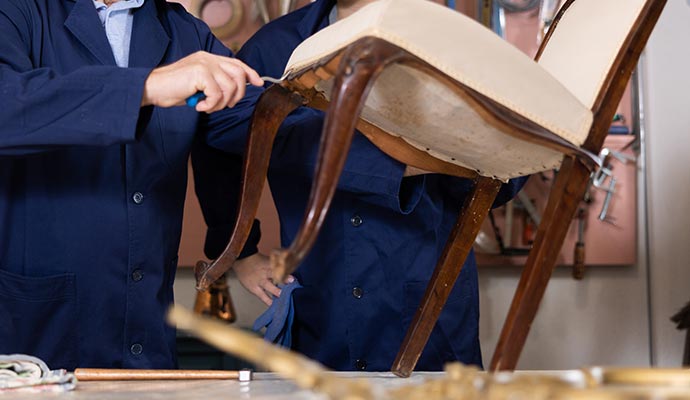 Professional team restoring furniture Skilled workers restoring damaged furniture