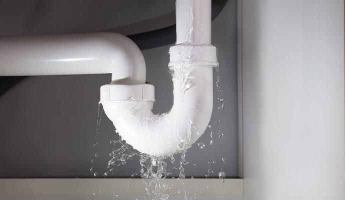 Water dripping and pooling from leaky pipe Water dripping and pooling from leaky pipe
